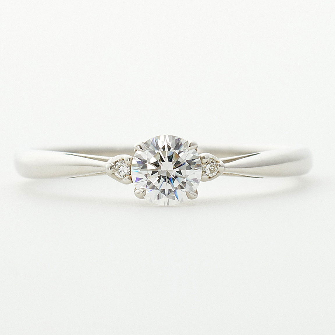 婚約指輪“シンプル“ | ダイヤモンドがカップ型の石座に収められ、サイドから眺めると、リングアームに透かしのような隙間がデザインされた、丸みが愛らしいエンゲージリング。